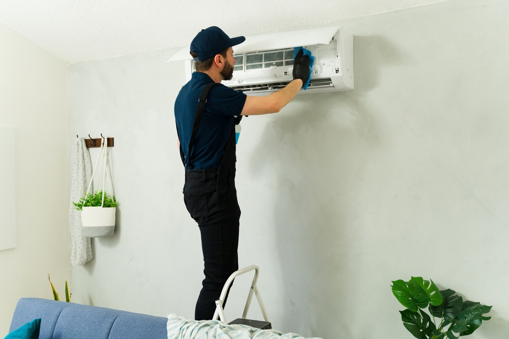 Dorking business owner with freshly serviced commercial air conditioning by CrispAC