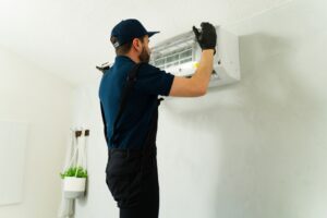 CrispAC engineer servicing a split air conditioning unit in Reigate